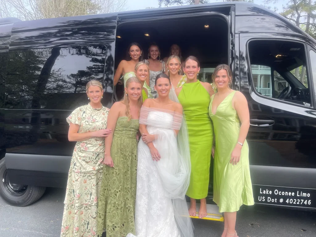 Wedding guests gathered beside a luxury vehicle for event transportation