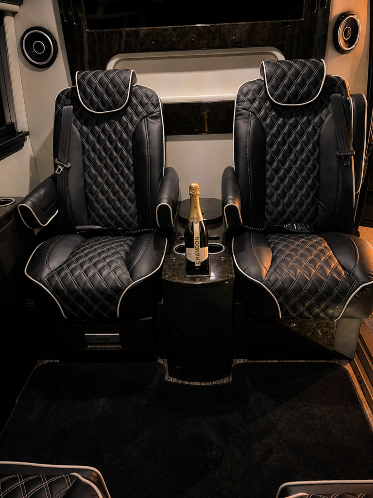 Premium black leather captain seats inside a luxury transportation vehicle